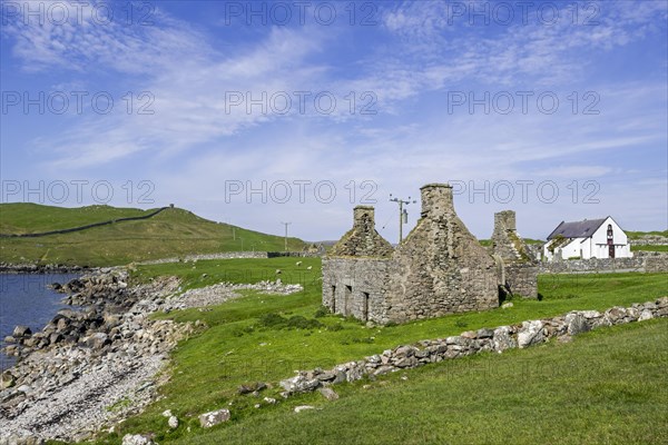 Ruin of old fishing booth and 18th century Lunna Kirk at East Lunna Voe