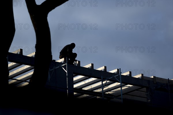 Two craftsmen silhouetted on a building site in Berlin