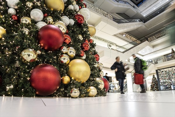 People stand out against Christmas decorations in a shopping centre on Schlossstrasse in Berlin