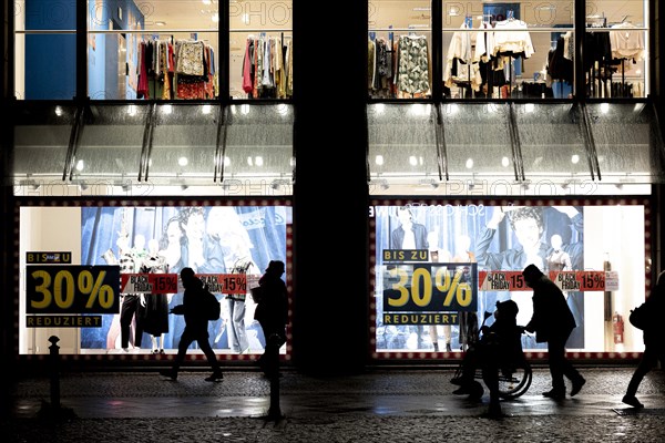 Signs indicating discounts stand out at a shopping centre on Schlossstrasse in Berlin