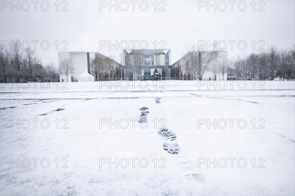 Footprints in the snow loom in front of the Chancellery in Berlin