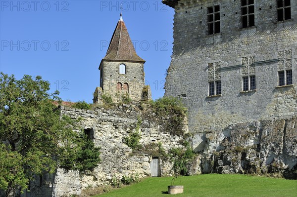 Church tower and the medieval castle Chateau de Lavardens in the Midi-Pyrenees