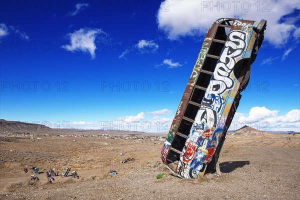 School bus sunk into the ground and sprayed with graffiti