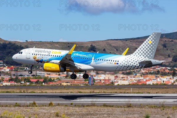 A Vueling Airbus A320 aircraft with registration EC-MLE and the 25 years Disneyland Paris special livery at Tenerife Airport