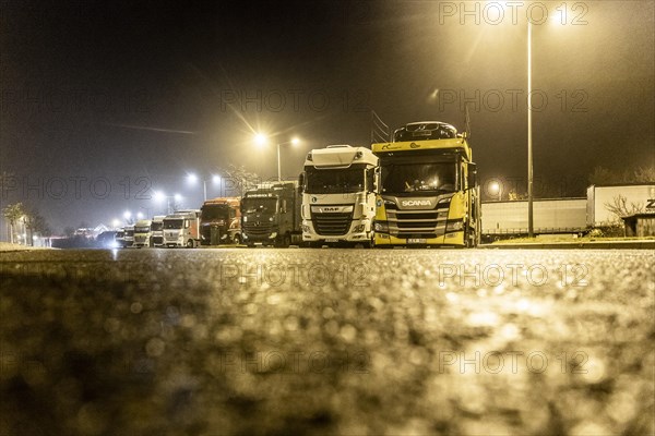 Trucks standing at night in fog at the Freienhufener Eck rest area near Schipkau