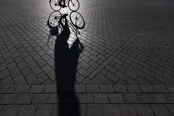 The silhouette of a cyclist stands out in Berlin