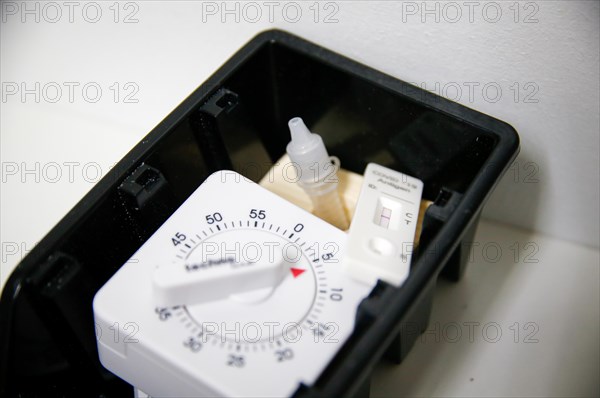 A rapid test with a stopwatch is ready in a tray for use in a COVID-19 vaccination and testing centre at Autohaus Olsen in Iserlohn