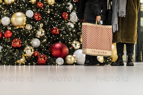 People stand out against Christmas decorations in a shopping centre on Schlossstrasse in Berlin