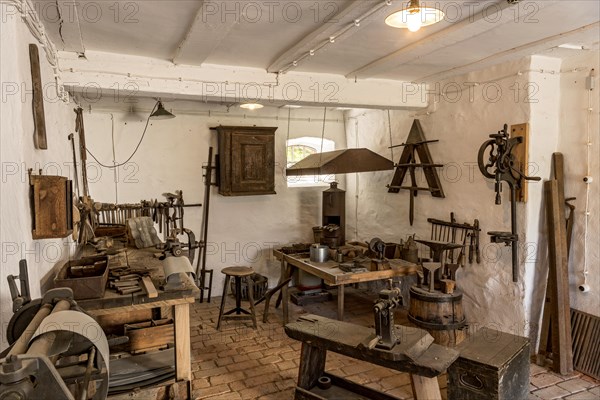 Workbench and tools in a tinsmith's workshop