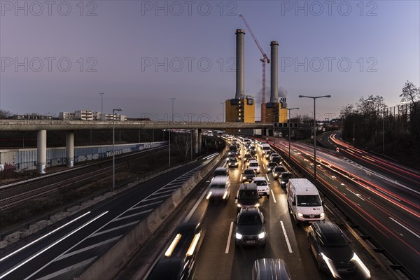 Congested traffic on the A100 with a view of the Wilmersdorf combined heat and power plant looms at blue hour in Berlin