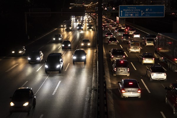 Congested traffic on the A100 looms at blue hour in Berlin