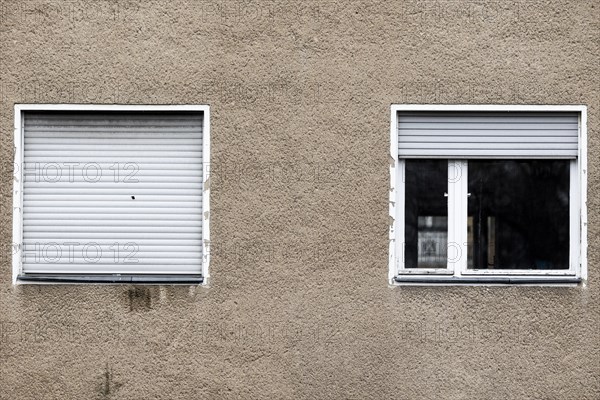 Lowered blinds stand out at an abandoned residential building in Berlin