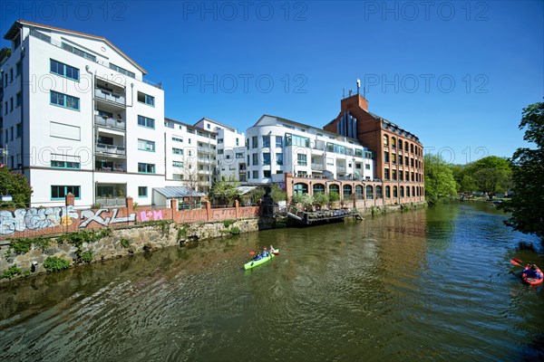 Modern residential buildings on the river Weisse Elster