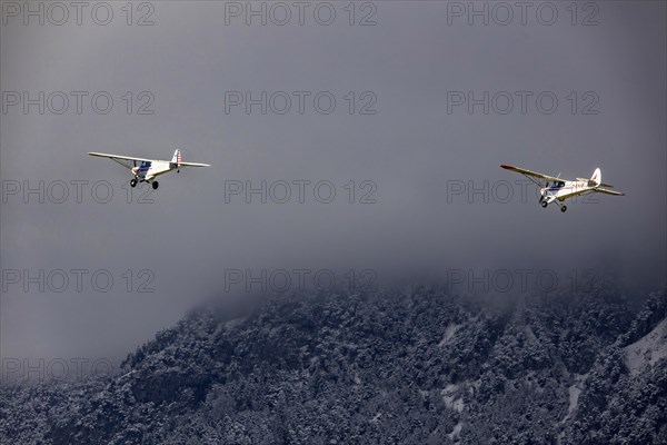 Two high-wing aircraft in formation flight