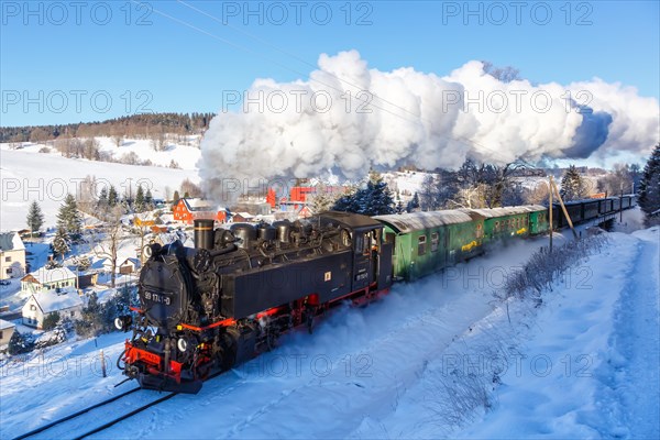 Steam train of the Fichtelbergbahn railway Steam locomotive in winter in Sehmatal