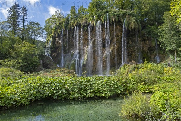 Waterfall and green tufa lake in the Plitvice Lakes National Park