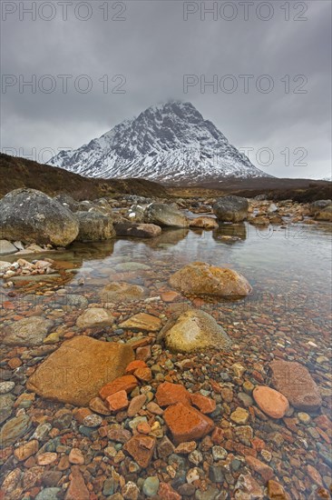 Scottish mountain Buachaille Etive Mor and waterfall on River Coupall in winter in Glen Etive near Glencoe in the Highlands of Scotland