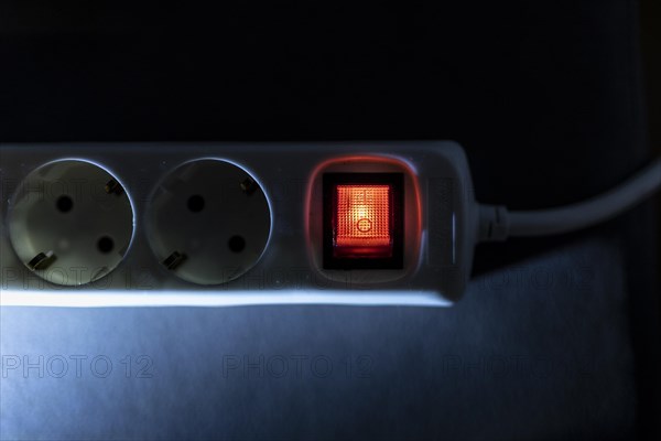 A distribution socket with a luminous switch