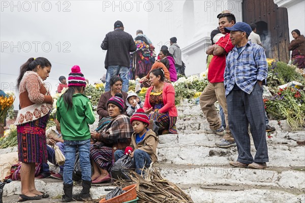Local people called Mayan K'iche selling flowers on market day in front of the church Iglesia de Santo Tomas in Chichicastenango