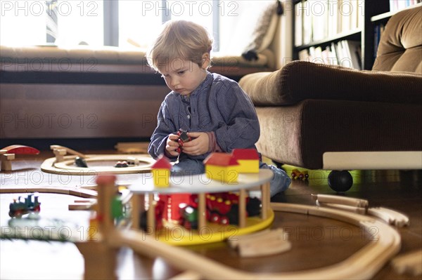 Toddler playing with a wooden railway