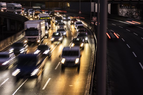 Congested traffic on the A100 looms at blue hour in Berlin