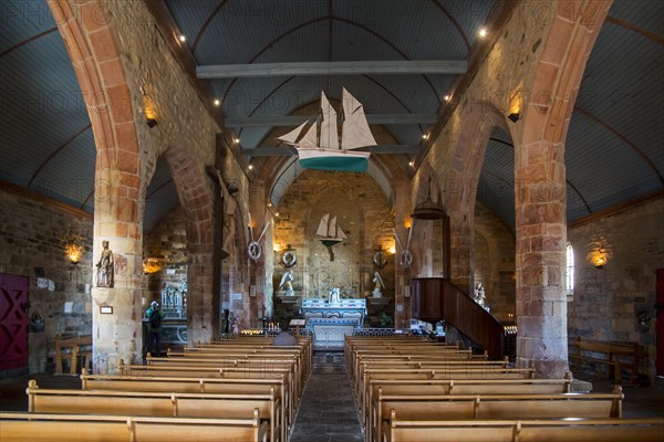 Interior of the Notre-Dame-de-Rocamadour chapel showing altar and ex-votos in the form of fishing boats