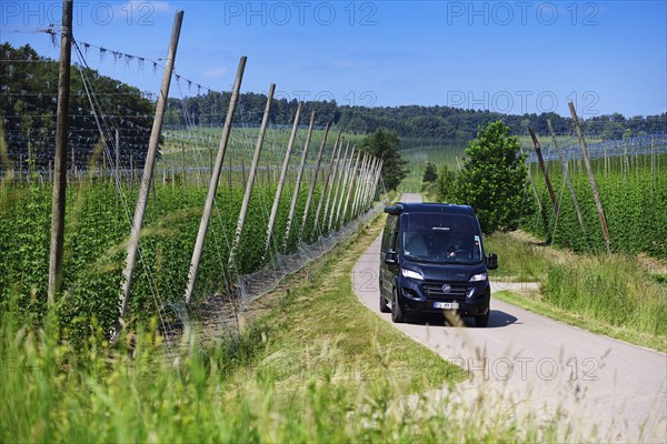 Motorhome driving through hop-growing area in the Hallertau