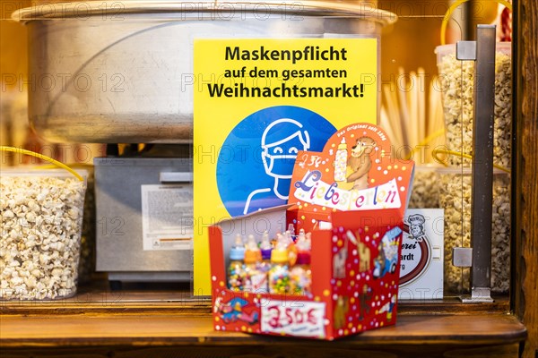 A sign indicating that masks are compulsory stands out at the Christmas market on Alexanderplatz in Berlin