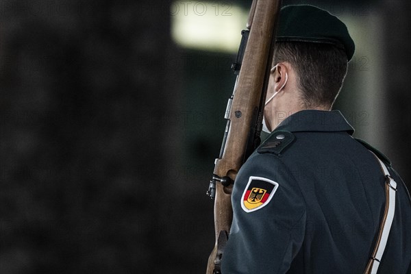 A soldier of the German Armed Forces wearing mouth-nose protection