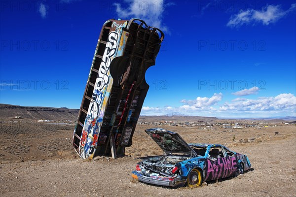 School bus and car sunk into the ground and sprayed with graffiti