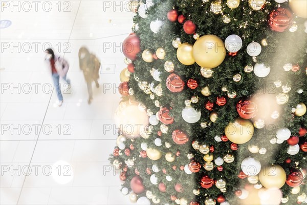 People stand out against Christmas decorations in a shopping centre on Schlossstrasse in Berlin