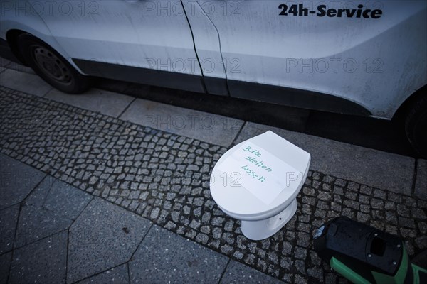 A toilet bowl stands on a pavement in Berlin Mitte. Berlin