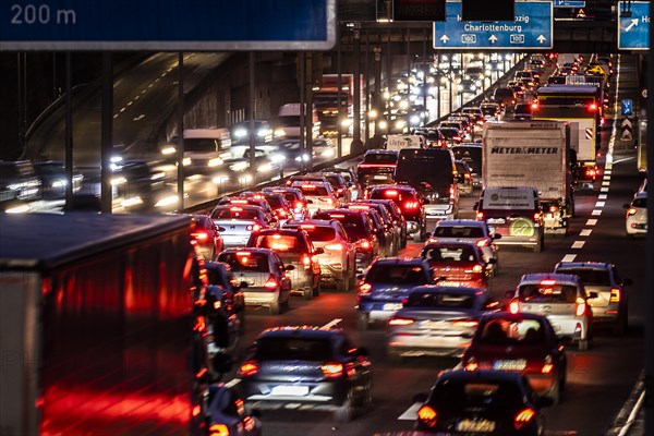 Congested traffic on the A100 looms at blue hour in Berlin