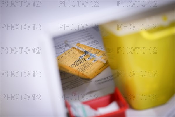 A vaccination certificate and a syringe containing Moderna Spikevax vaccine lie in a vaccination booth at a COVID-19 vaccination and testing centre at Autohaus Olsen in Iserlohn