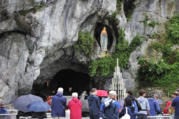 Pilgrims praying in front of the grotto at the Sanctuary of Our Lady of Lourdes