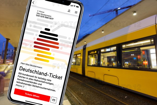 Germany ticket D-ticket or 49 euro ticket on a mobile phone with tram Tram photo montage in Berlin