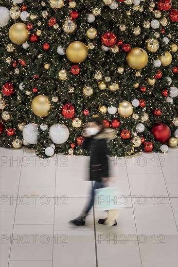 People stand out against Christmas decorations in a shopping centre on Schlossstrasse in Berlin