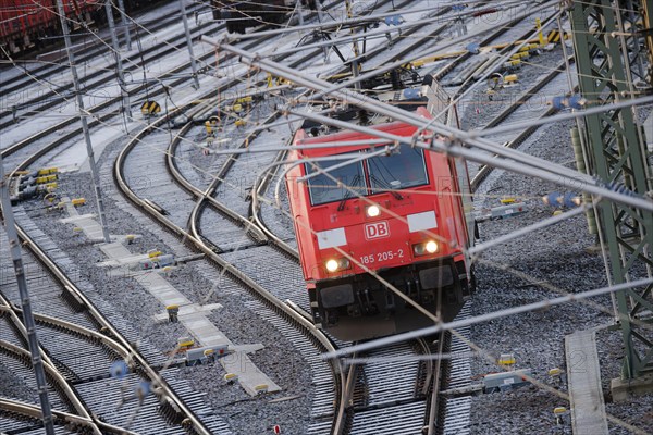 An electric locomotive of DB Cargo runs over the freight station Halle