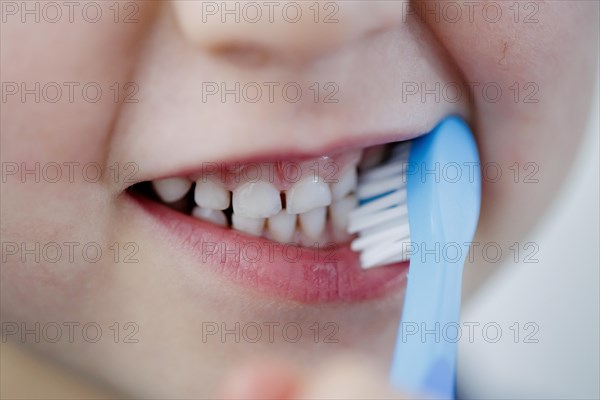 Symbolic photo on the subject of dental care for children. A boy brushes his teeth. Berlin