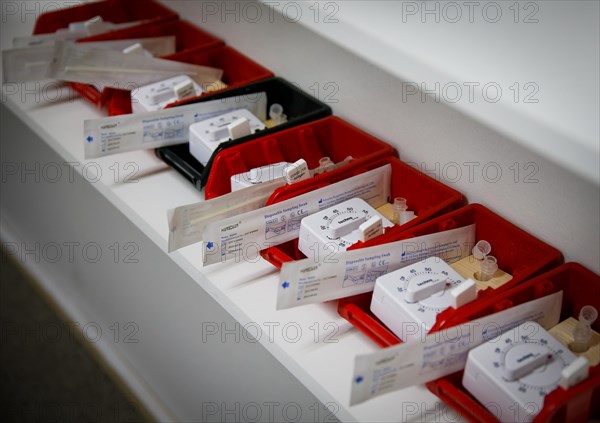 Rapid tests with stopwatches are ready in trays for use in a COVID-19 vaccination and testing centre at Autohaus Olsen in Iserlohn