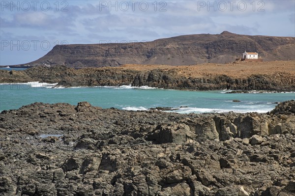 Praia de Fatima and abandoned chapel of Our Lady of Fatima looking over the rugged coast and cliffs near Sal Rei on the island Boa Vista