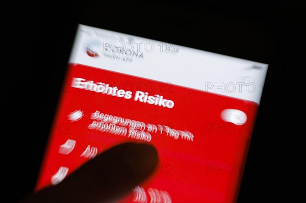 The Corona Warn app displays the words Increased Risk on a smartphone. Berlin