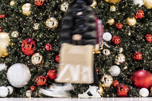 People stand out against Christmas decorations in a shopping centre on Schlossstrasse in Berlin