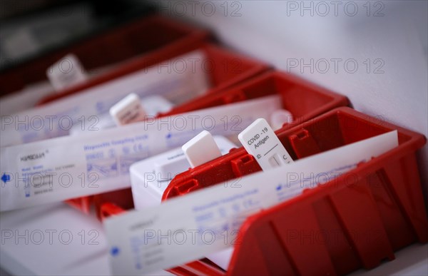 Rapid tests with stopwatches are ready in trays for use in a COVID-19 vaccination and testing centre at Autohaus Olsen in Iserlohn