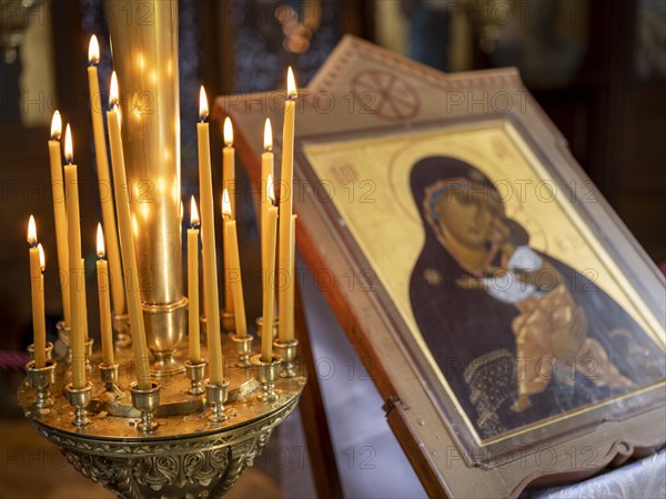 Burning candles next to an icon in the Russian Chapel