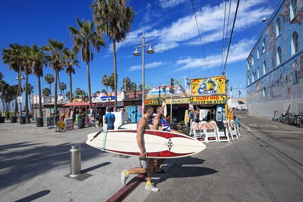 Surfers in front of Jay's Surf