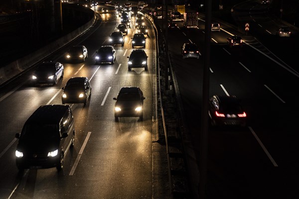 Congested traffic on the A100 looms at blue hour in Berlin