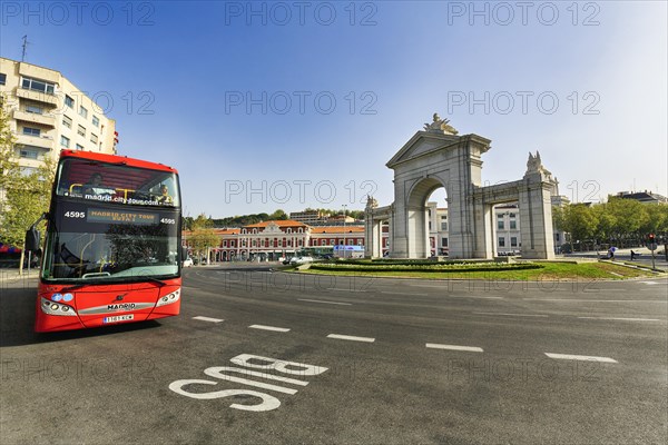 Monumental gate Puerta de San Vicente in a roundabout