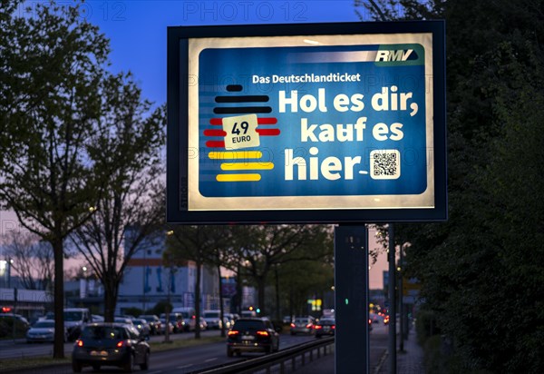Advertising poster for the Deutschlandticket on a busy motorway