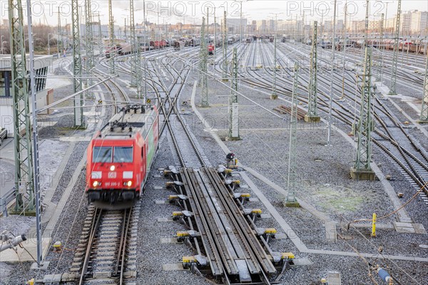 An electric locomotive of DB Cargo runs over the freight station Halle